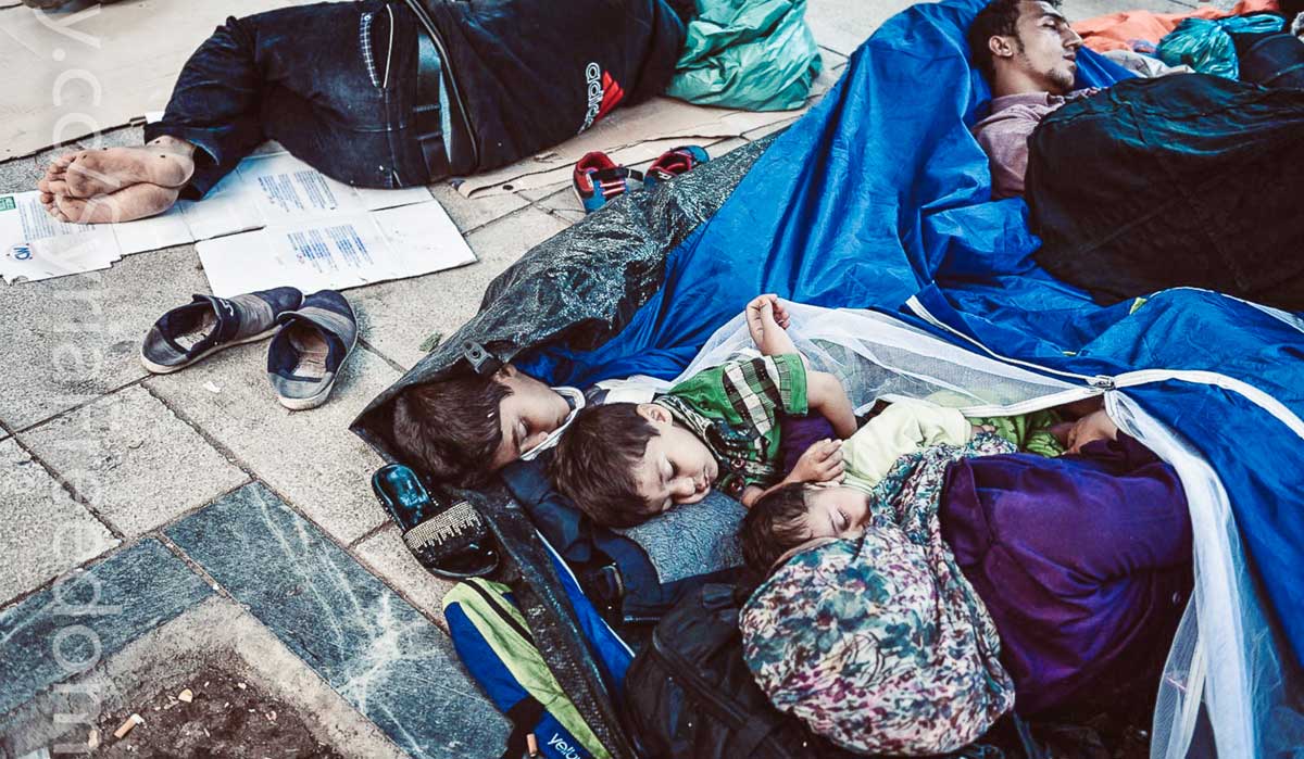 Refugee family sleeping in the street